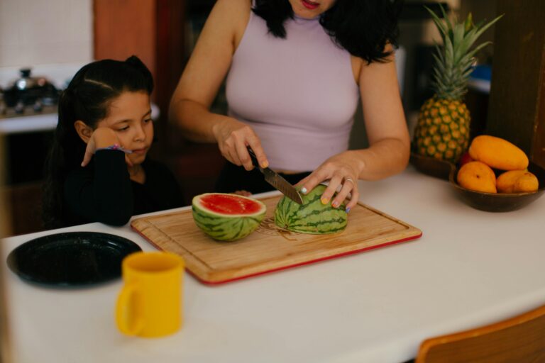 gesunde sommer snacks kinder, Kind und Mutter schneiden Wassermelone für einen sommerlichen Znüni